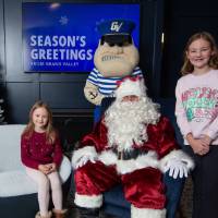 Sisters smile with Santa and Louie